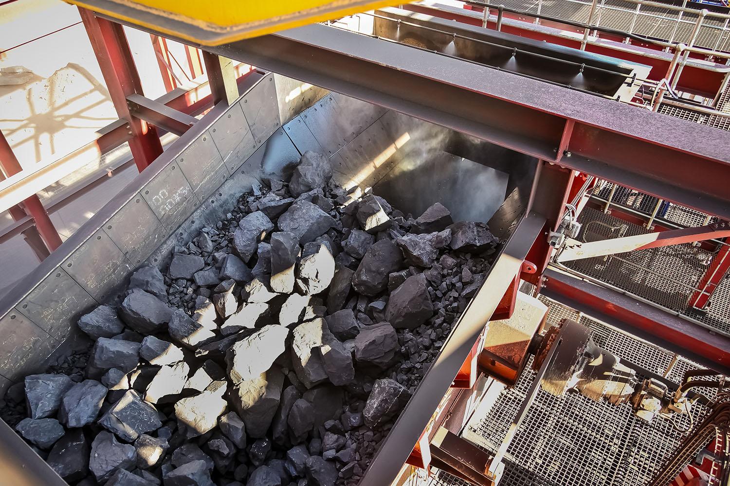 Bulk material moving through industrial handling equipment