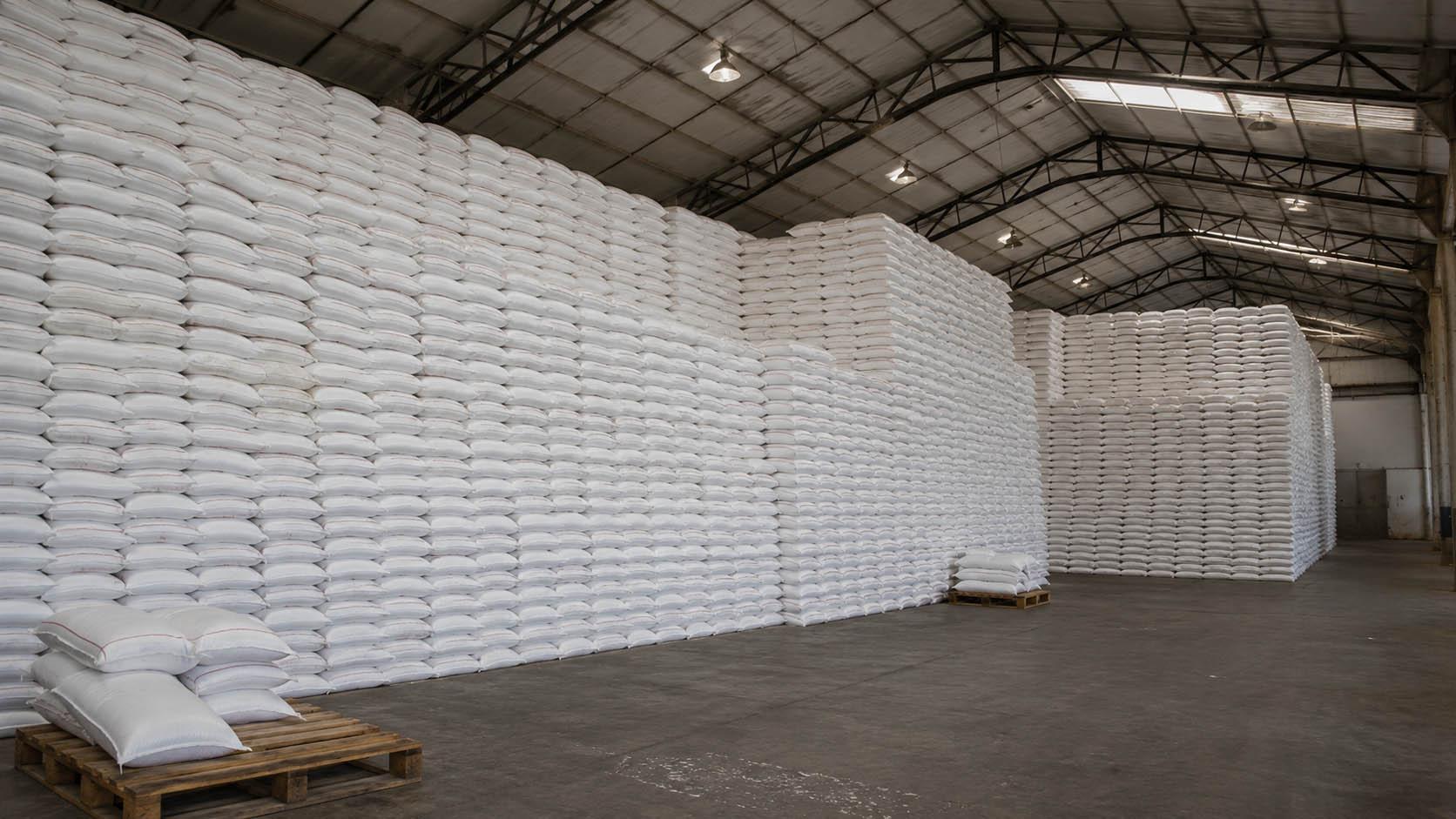 Bagged sugar being handled in a warehouse