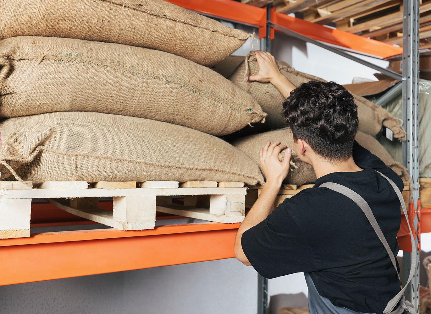 Bagged coffee being checked in storage